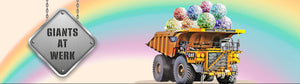 Mining haul truck with giant balloons in rear bucket on a rainbow background and text 'Old Town New Queens Giants at Werk'.